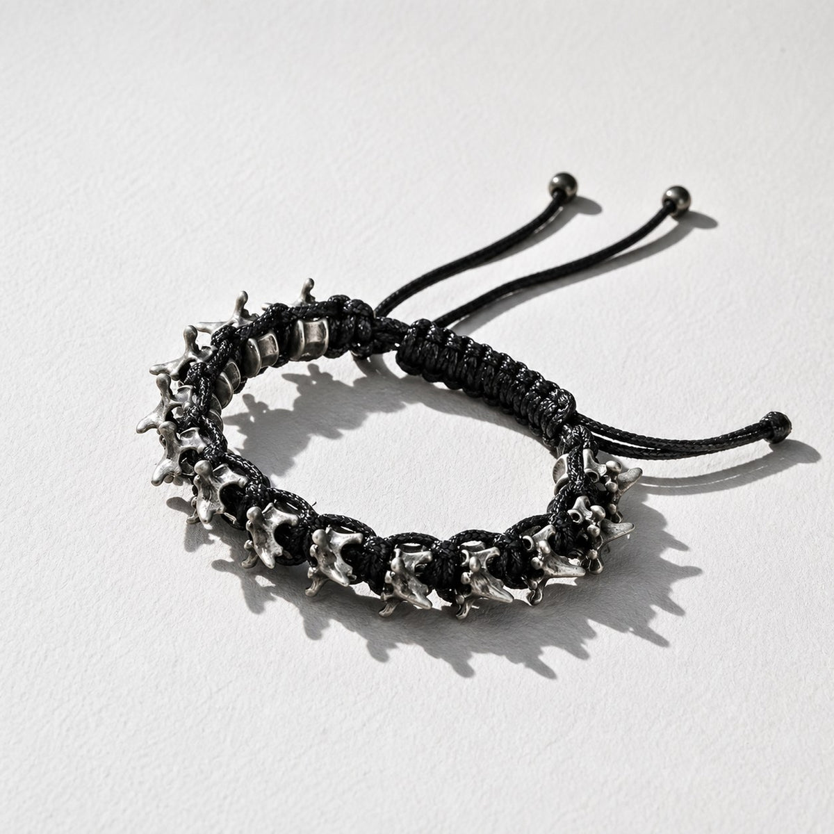 Dark Gothic Dragon Spine Bracelet — black braided cord — Drokt